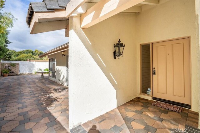 303 Calle Escuela, San Clemente, CA 92672 - doorway to property featuring stucco siding, fence, and a patio