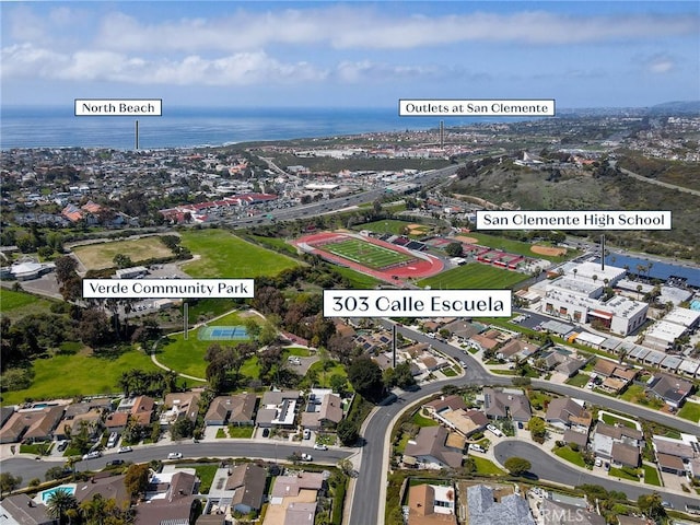 aerial view of property and surrounding area featuring a nearby body of water
