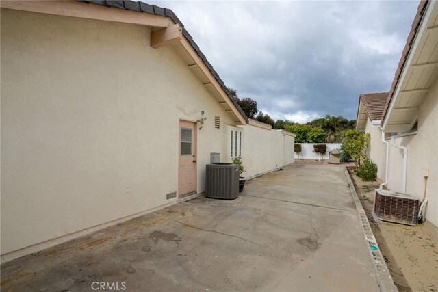 303 Calle Escuela, San Clemente, CA 92672 - view of property exterior featuring central AC, stucco siding, and a fenced backyard