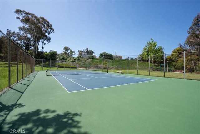 view of tennis court with fence