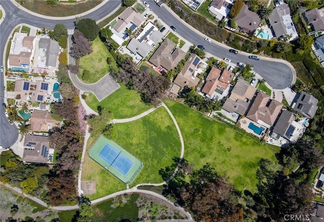 aerial view of property and surrounding area featuring nearby suburban area