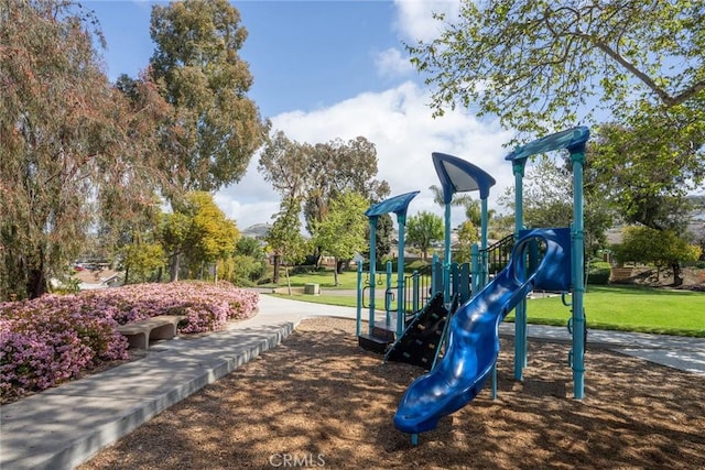 communal playground featuring a lawn