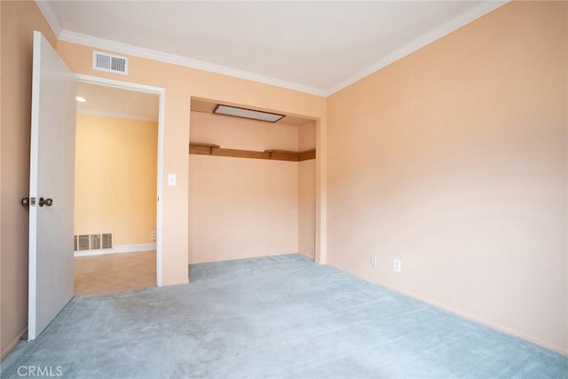 unfurnished bedroom with carpet flooring, ornamental molding, and a closet