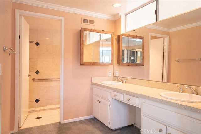 bathroom featuring tiled shower, crown molding, double vanity, baseboards, and tile patterned flooring