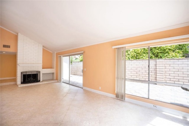 unfurnished living room with crown molding, a fireplace, baseboards, and lofted ceiling