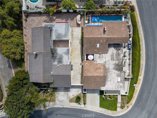 aerial view of property and surrounding area featuring a pool