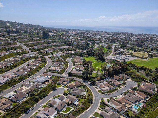 view of property location featuring a large body of water and nearby suburban area