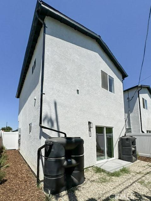 10430 Densmore Ave, Granada Hills, CA 91344 - back of house with stucco siding and fence