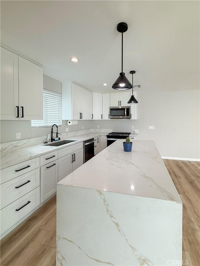 10430 Densmore Ave, Granada Hills, CA 91344 - kitchen featuring a sink, appliances with stainless steel finishes, a center island, light wood-style flooring, and white cabinetry