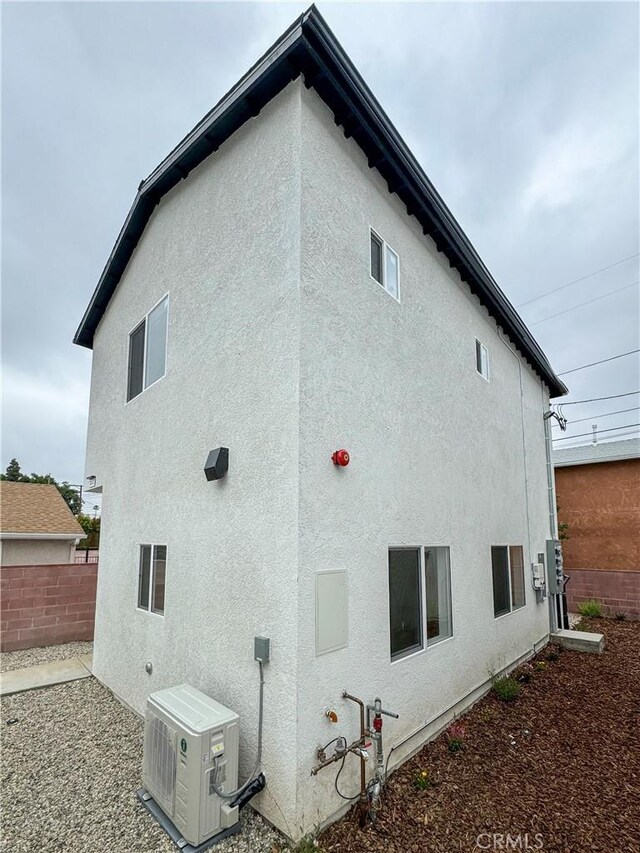 10430 Densmore Ave, Granada Hills, CA 91344 - rear view of house featuring stucco siding, fence, and a cooling unit