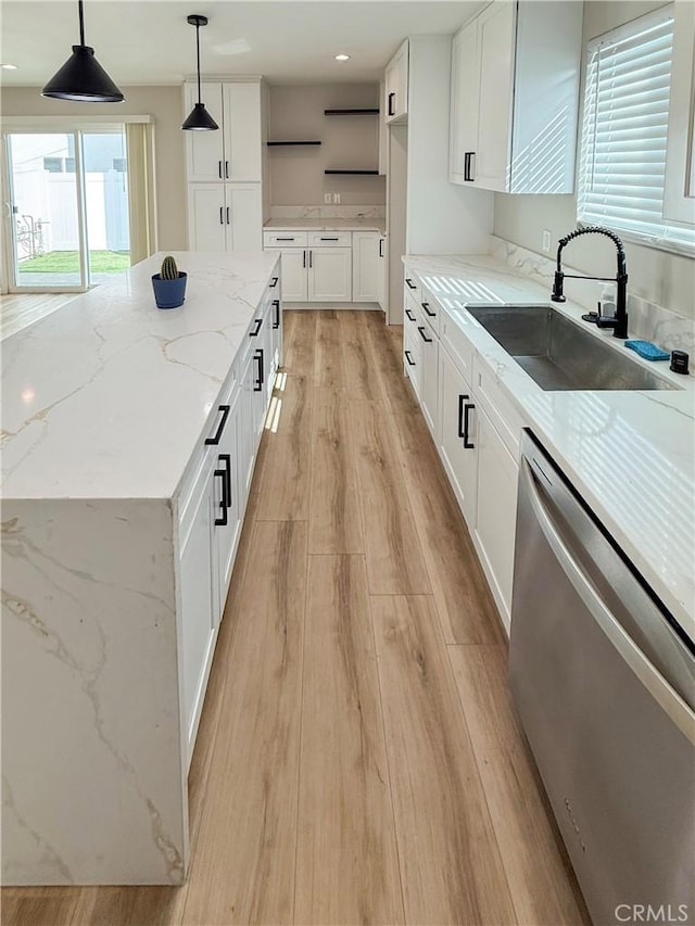 10430 Densmore Ave, Granada Hills, CA 91344 - kitchen featuring dishwasher, a sink, light wood-type flooring, pendant lighting, and white cabinetry
