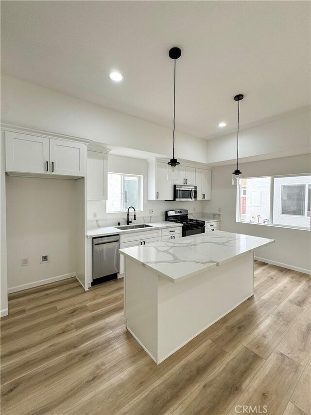 10430 Densmore Ave, Granada Hills, CA 91344 - kitchen with stainless steel appliances, a sink, white cabinets, recessed lighting, and light wood finished floors