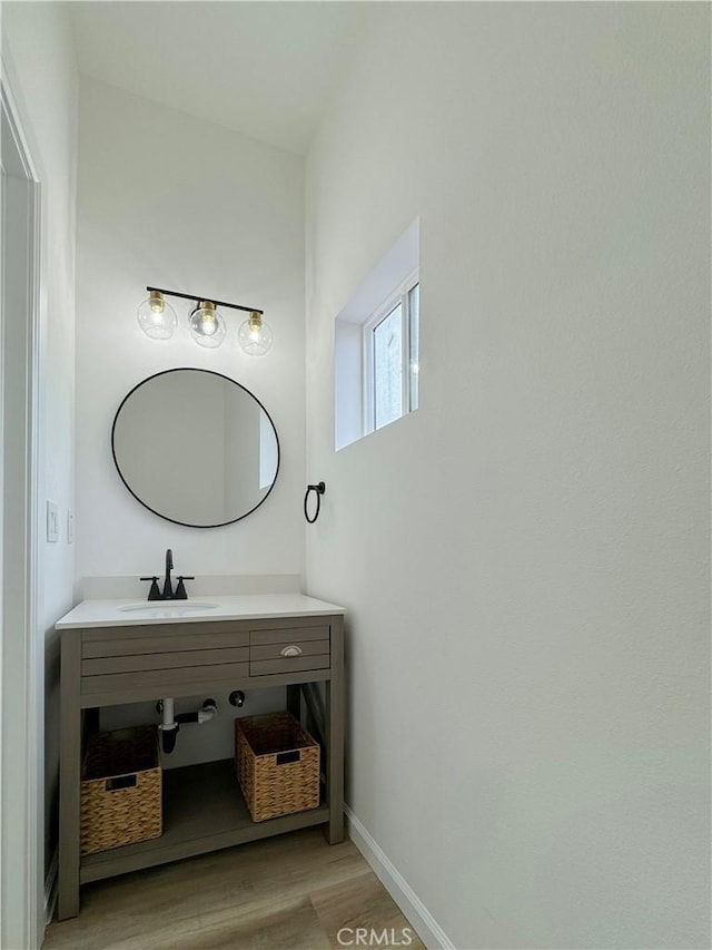 10430 Densmore Ave, Granada Hills, CA 91344 - bathroom featuring a sink, wood finished floors, and baseboards