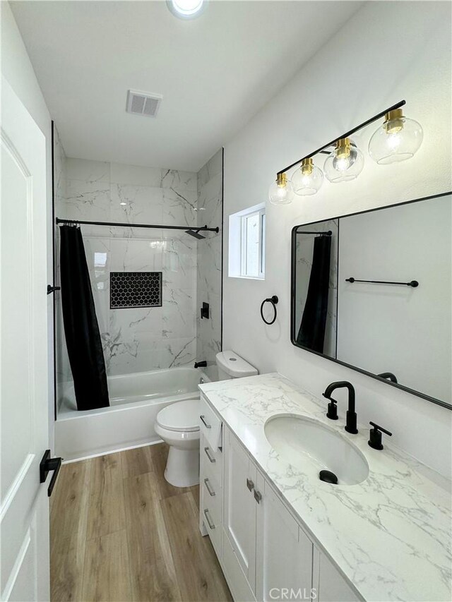 10430 Densmore Ave, Granada Hills, CA 91344 - bathroom featuring toilet, wood finished floors, shower / bath combo with shower curtain, and vanity