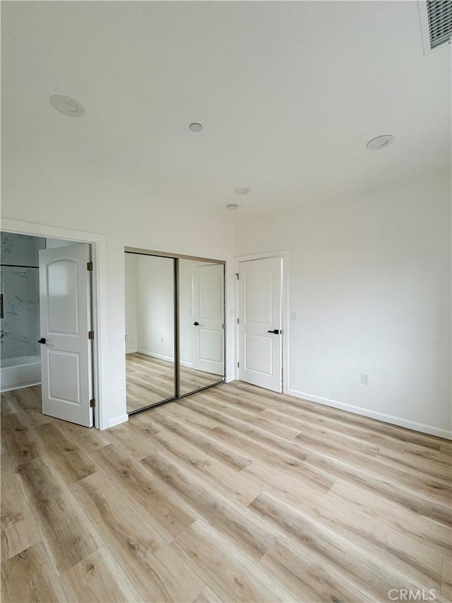 10430 Densmore Ave, Granada Hills, CA 91344 - unfurnished bedroom with light wood finished floors, a closet, and baseboards