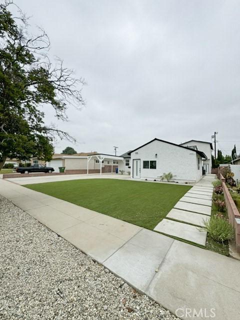 10430 Densmore Ave, Granada Hills, CA 91344 - view of front of house featuring a front lawn