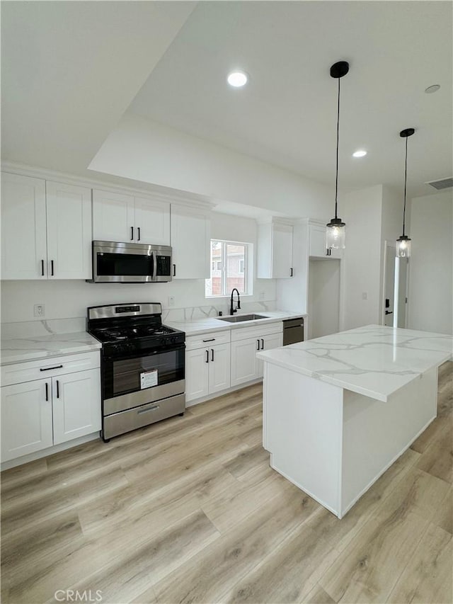 10430 Densmore Ave, Granada Hills, CA 91344 - kitchen featuring stainless steel appliances, a sink, white cabinets, light wood-type flooring, and recessed lighting