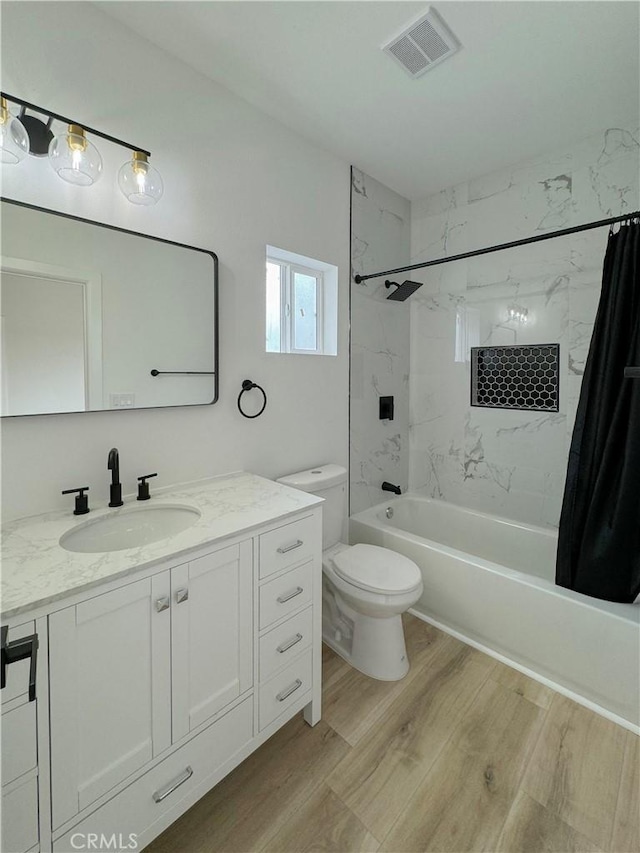 10430 Densmore Ave, Granada Hills, CA 91344 - bathroom with shower / bath combination with curtain, wood finished floors, vanity, and toilet