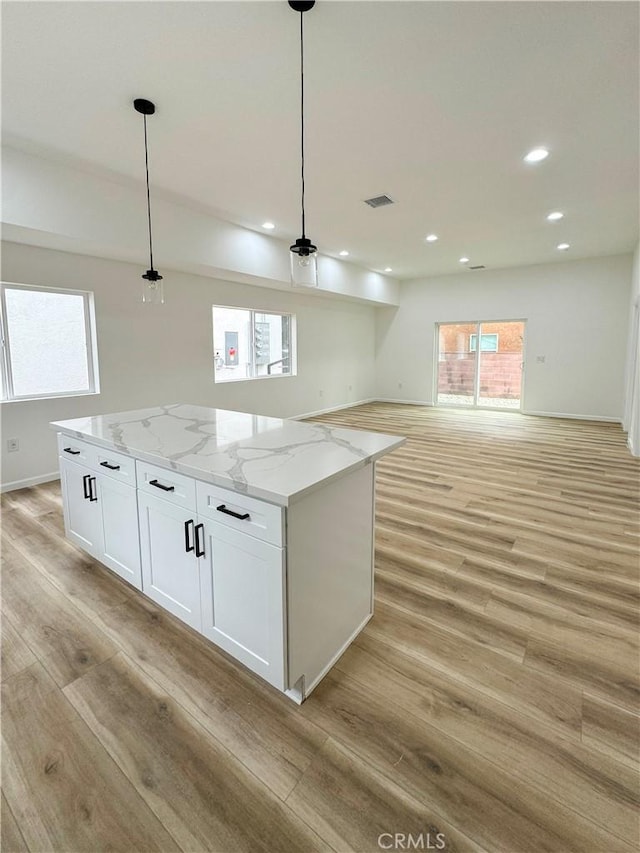 10430 Densmore Ave, Granada Hills, CA 91344 - kitchen featuring light wood-style floors, white cabinets, healthy amount of natural light, and recessed lighting