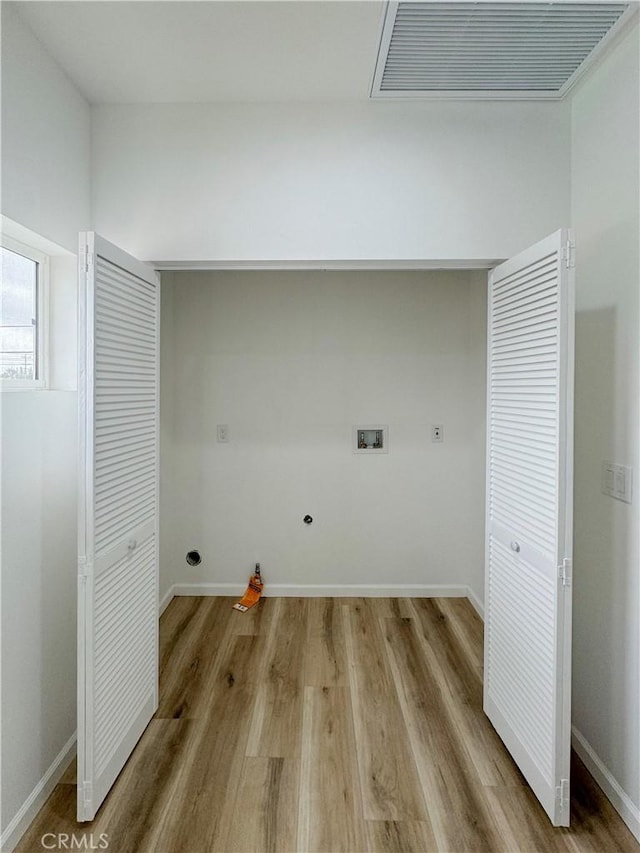 10430 Densmore Ave, Granada Hills, CA 91344 - laundry area featuring washer hookup, wood finished floors, baseboards, and hookup for an electric dryer