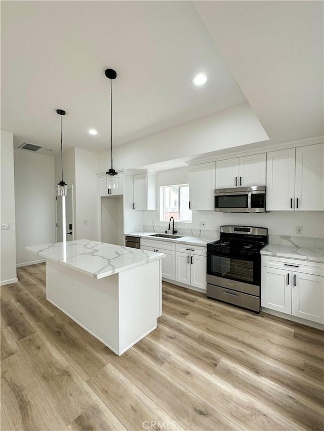 10430 Densmore Ave, Granada Hills, CA 91344 - kitchen featuring stainless steel appliances, a sink, white cabinetry, and recessed lighting