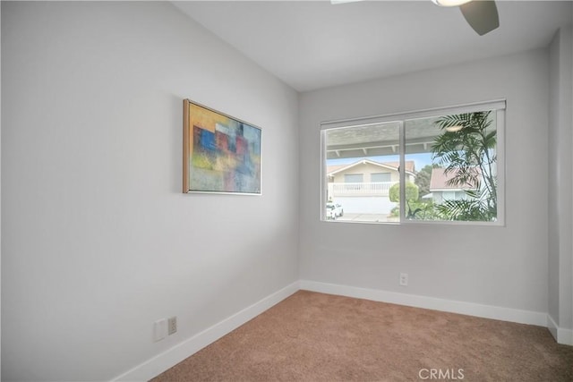 unfurnished room with carpet floors, baseboards, and a ceiling fan