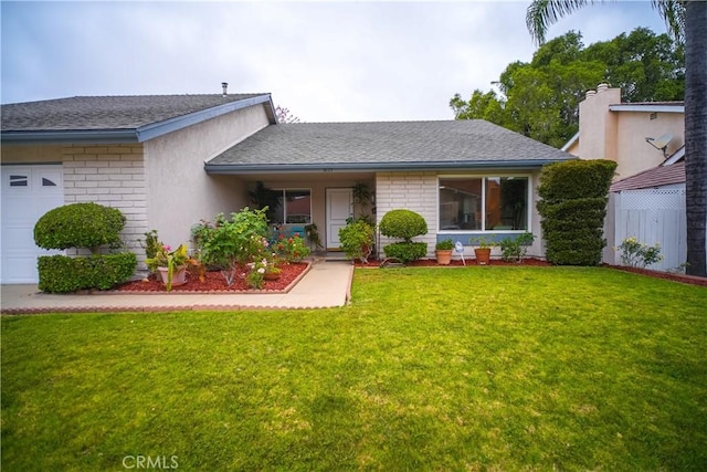 ranch-style house featuring a front lawn, a shingled roof, an attached garage, and brick siding