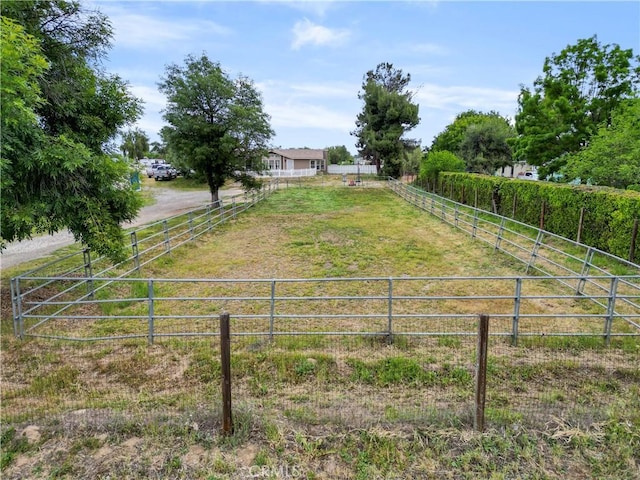 view of yard featuring a view of countryside and fence