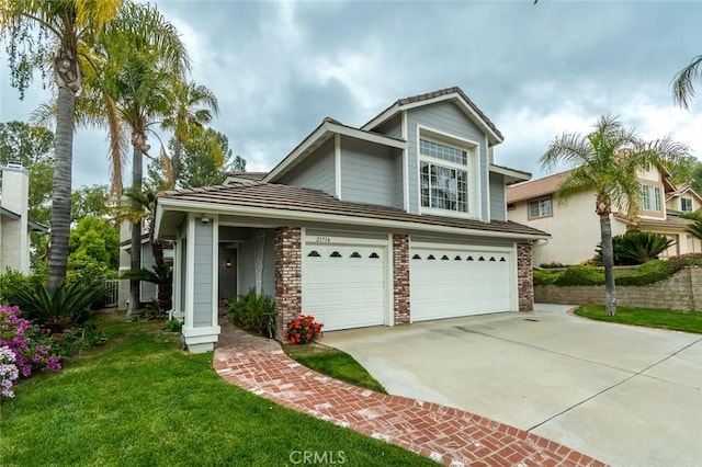21714 Agajanian Ln, Saugus, CA 91350 - traditional-style home featuring driveway, a garage, a front yard, and brick siding
