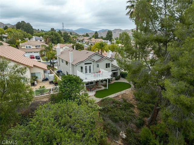 21714 Agajanian Ln, Saugus, CA 91350 - back of house with a fenced backyard, a residential view, stucco siding, and a deck with mountain view