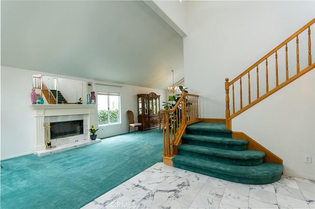 21714 Agajanian Ln, Saugus, CA 91350 - carpeted living area featuring stairs, baseboards, a high ceiling, a chandelier, and marble look tiles