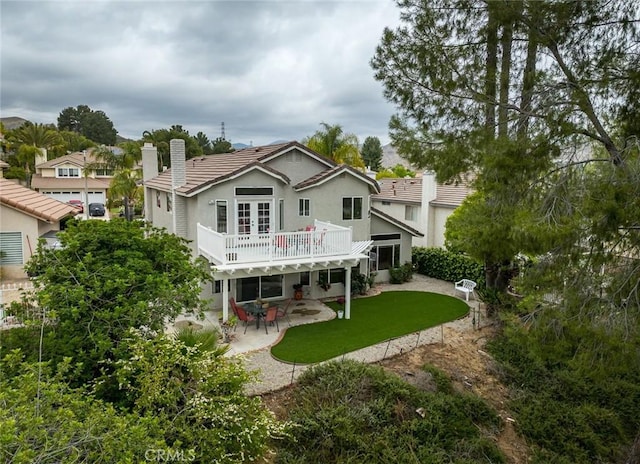 21714 Agajanian Ln, Saugus, CA 91350 - rear view of house with a patio area, a chimney, stucco siding, a wooden deck, and a lawn