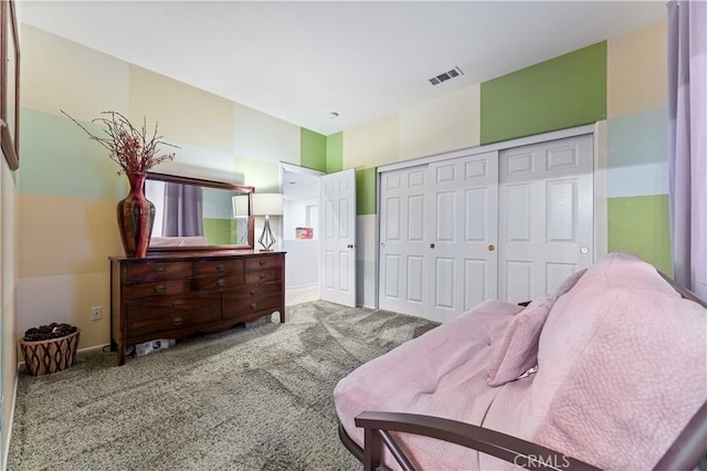 carpeted bedroom featuring a closet and baseboards