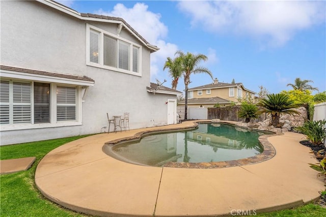 view of pool with a fenced backyard and a patio area