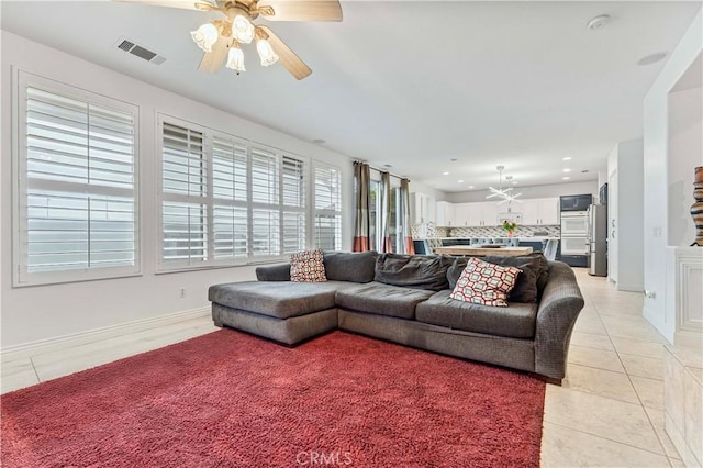living area with light tile patterned floors, ceiling fan, and recessed lighting