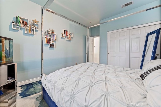 bedroom with a closet and baseboards