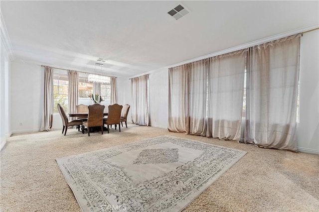 dining area featuring carpet, a chandelier, and baseboards