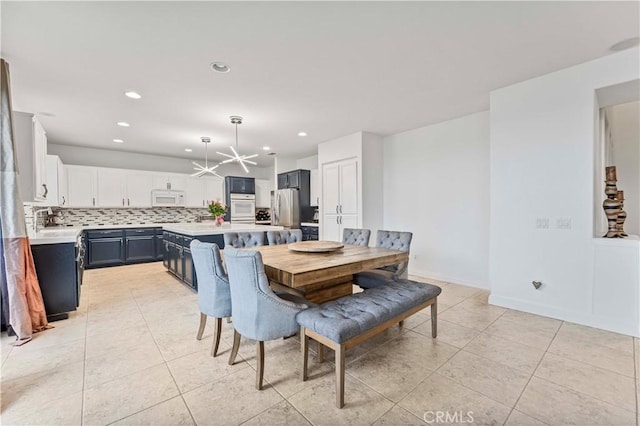 dining room featuring light tile patterned flooring, recessed lighting, and baseboards