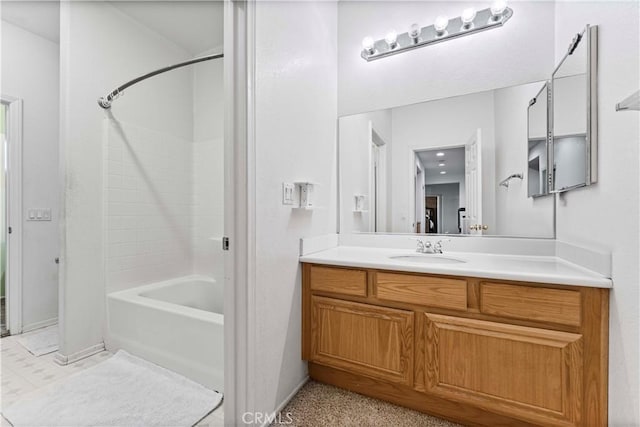 bathroom with vanity,  shower combination, and baseboards