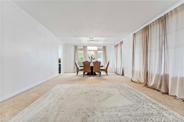 dining space featuring ornamental molding, baseboards, and light carpet