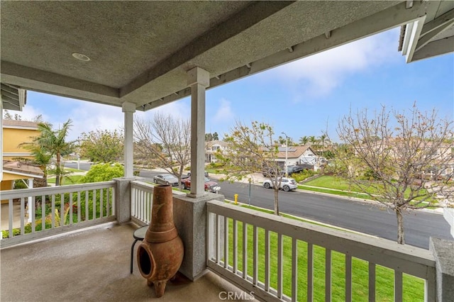 balcony featuring covered porch and a residential view