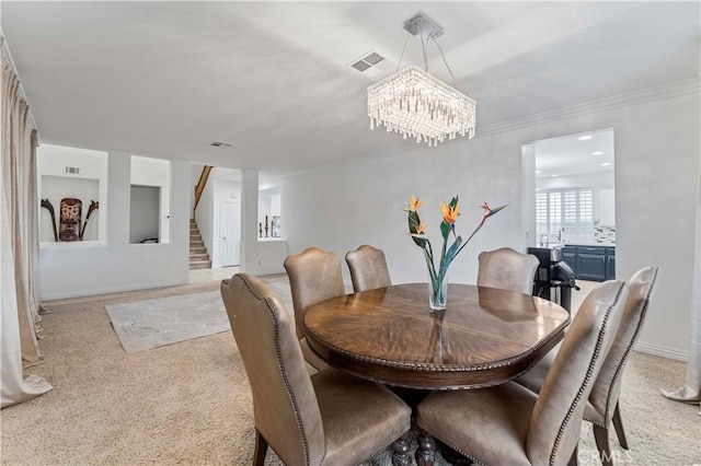 dining area with stairway, a chandelier, crown molding, light colored carpet, and baseboards