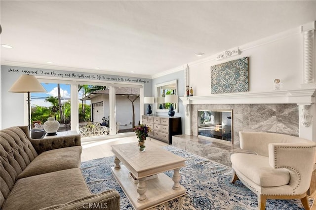 living area featuring ornamental molding, a high end fireplace, wood finished floors, and recessed lighting