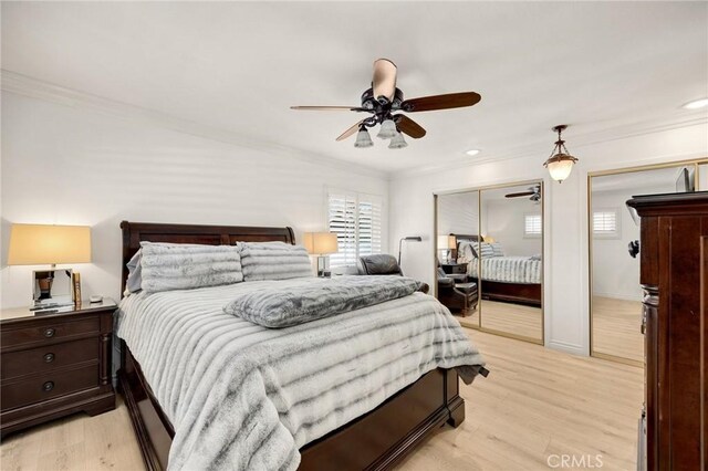 bedroom with multiple closets, crown molding, light wood-type flooring, recessed lighting, and a ceiling fan
