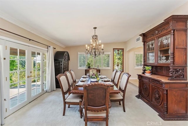 37895 Avenida Bravura, Temecula, CA 92592 - dining space featuring arched walkways, french doors, a chandelier, light colored carpet, and healthy amount of natural light