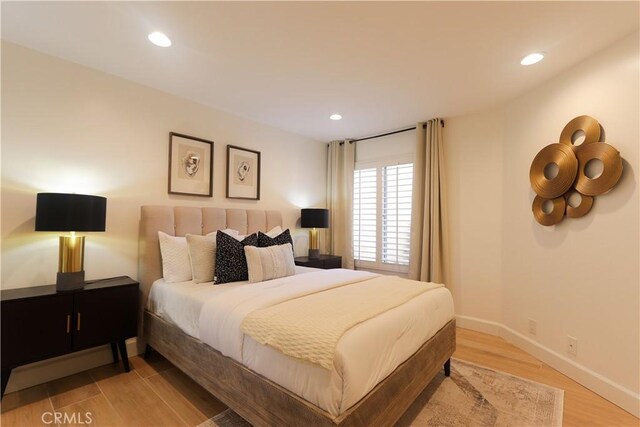 bedroom with light wood-type flooring, recessed lighting, and baseboards
