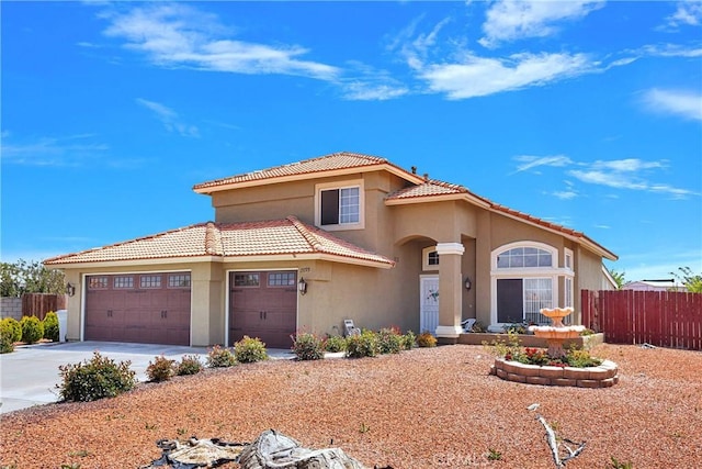 15199 Farmington Ct, Hesperia, CA 92345 - mediterranean / spanish house with fence, stucco siding, concrete driveway, a garage, and a tile roof
