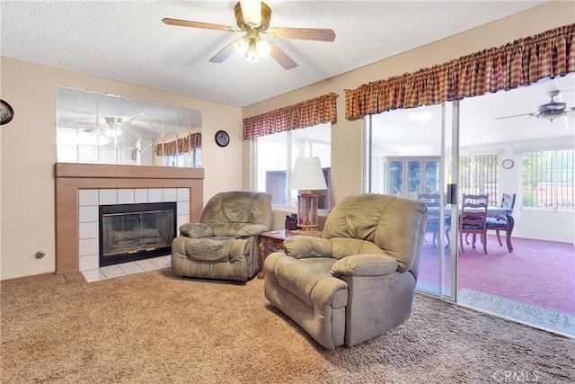 15199 Farmington Ct, Hesperia, CA 92345 - carpeted living room with ceiling fan, a tiled fireplace, and a textured ceiling