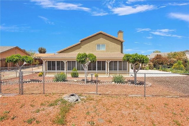 15199 Farmington Ct, Hesperia, CA 92345 - view of front facade featuring a sunroom, a chimney, stucco siding, and a gate