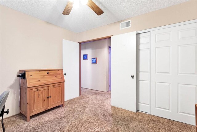 15199 Farmington Ct, Hesperia, CA 92345 - unfurnished bedroom featuring light carpet, a textured ceiling, a ceiling fan, and a closet